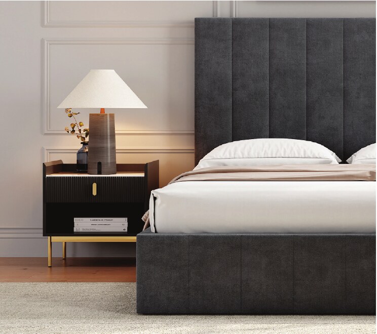 Close-up of a dark upholstered bed and bedside table