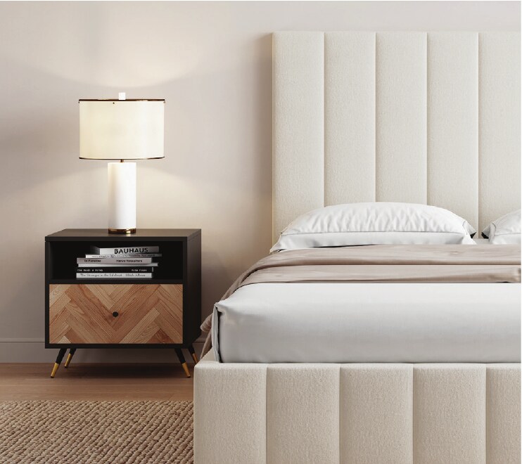 Close-up of a cream upholstered bed and bedside table